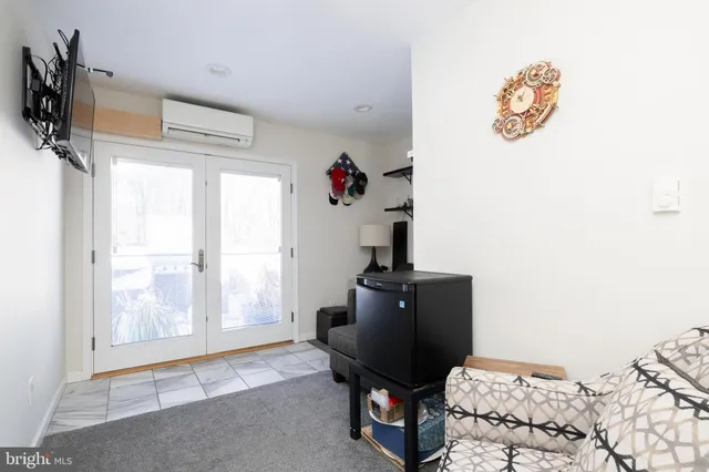 a view of a house with potted plants and a table and chairs