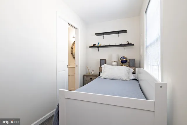 a bedroom with a bed and mirror