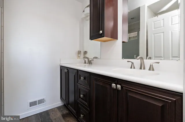 a bedroom with two beds and a large window
