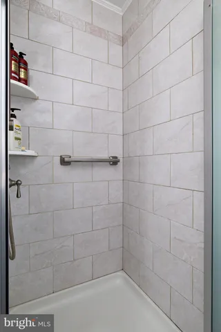 a view of a house with a large tree and wooden fence