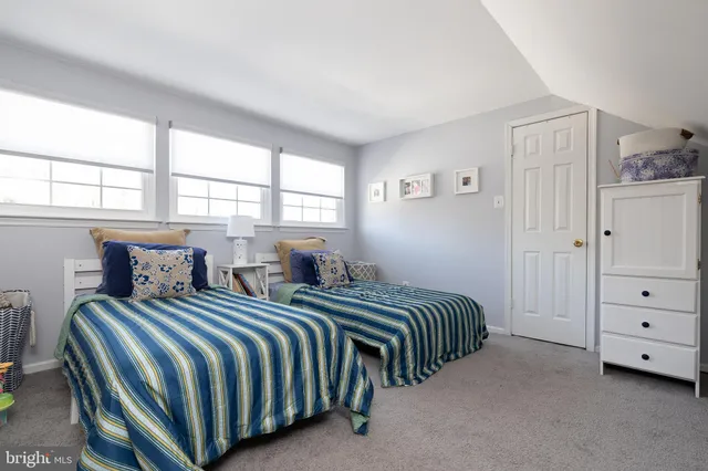 a front view of a house with a garden and plants