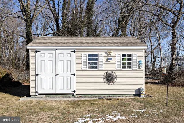 a view of a patio with table and chairs potted plants and palm trees