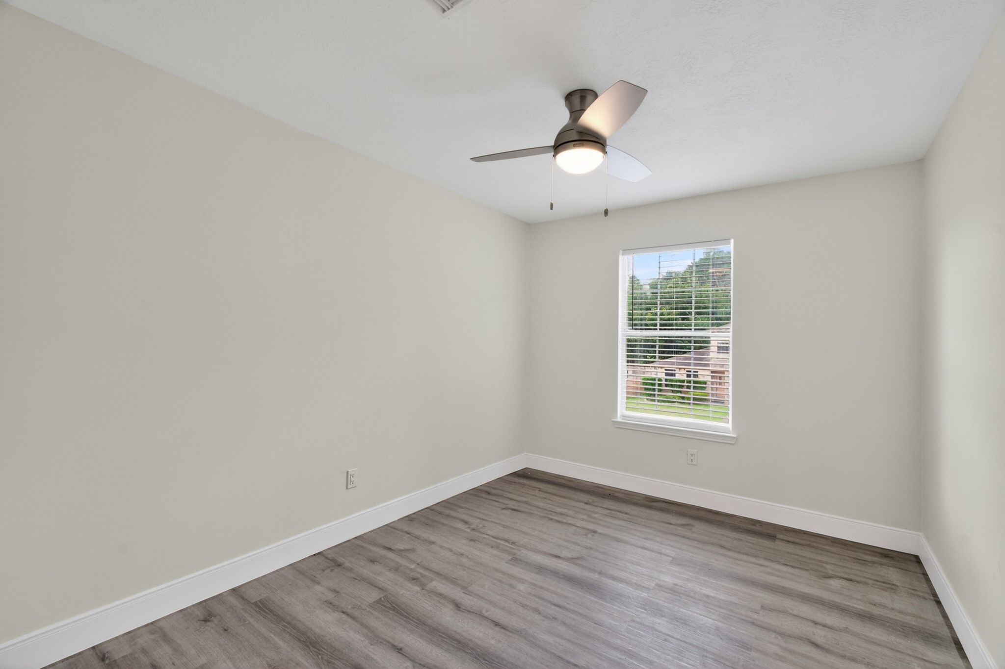 918 Ivycroft Lane Spring, TX 77373 - Photo 25 of 33 an empty room with wooden floor fan and windows