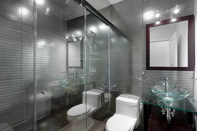 a bathroom with a toilet sink and shower