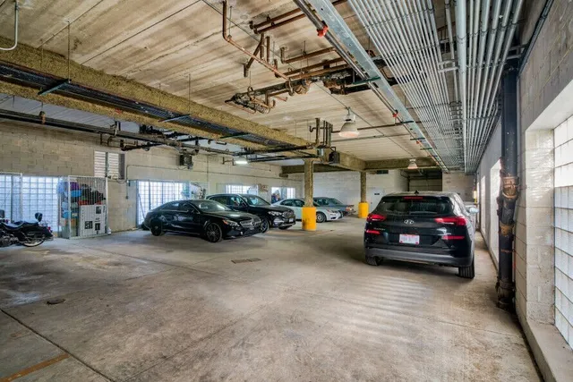 a view of parking garage with cars