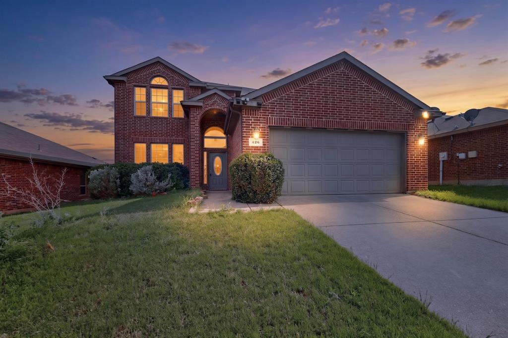 426 Harding Lane Lavon, TX 75166 - Photo 1 of 40 Brick exterior residence featuring an arched entryway and a two-car garage