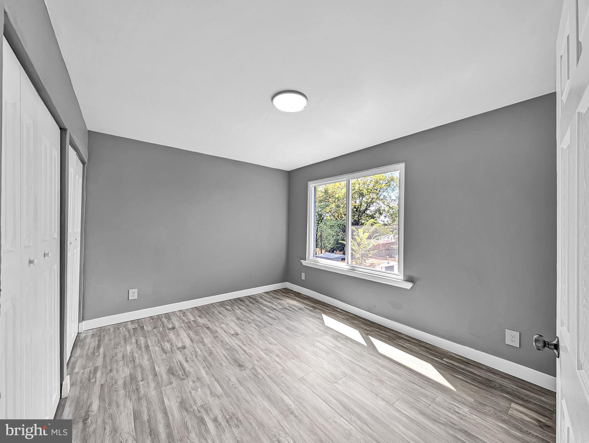 2240 15th Street Northeast Washington, DC 20018 - Photo 11 of 22 a view of an empty room with wooden floor and a window