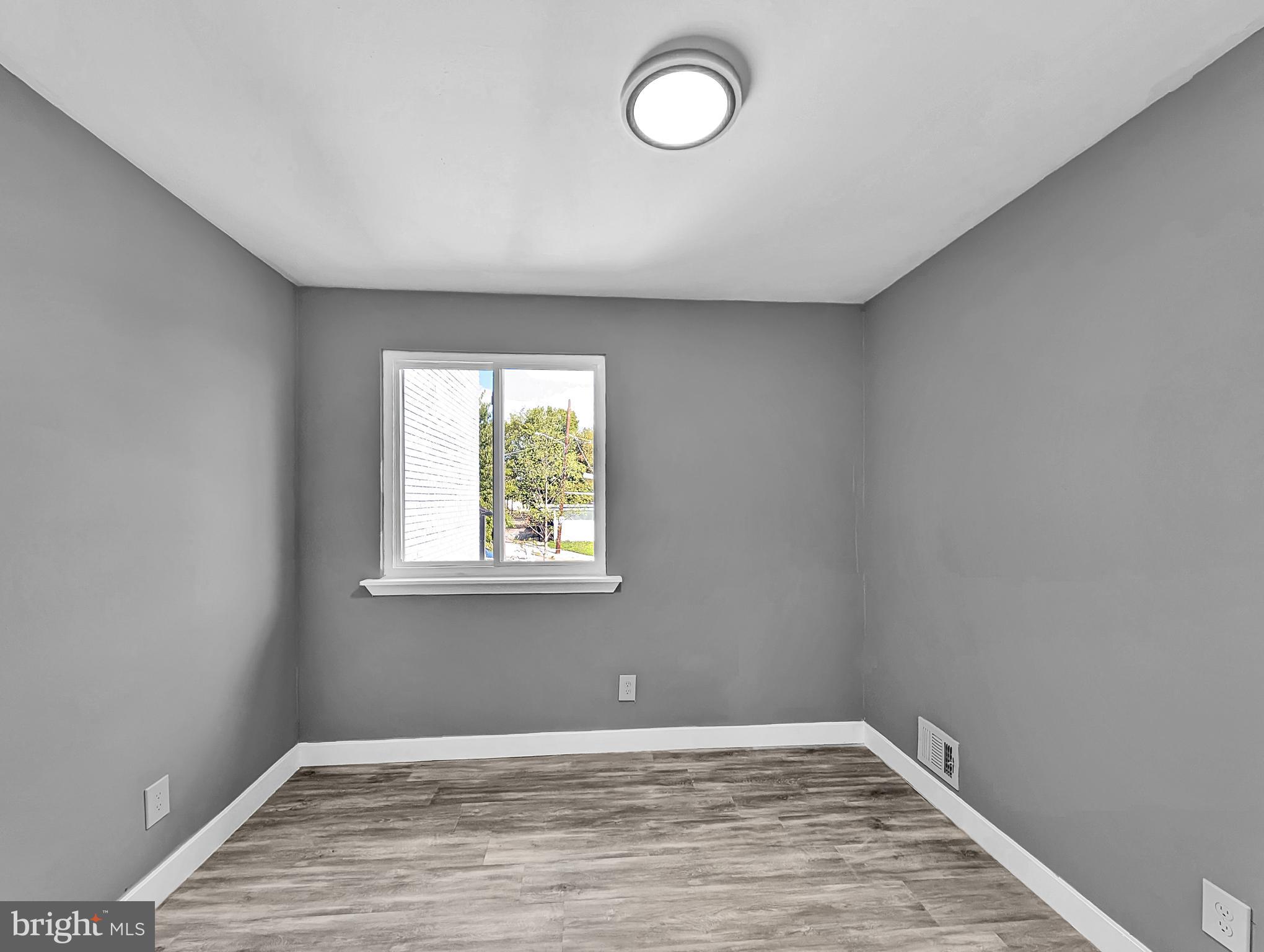2240 15th Street Northeast Washington, DC 20018 - Photo 15 of 22 a view of an empty room with wooden floor and a window