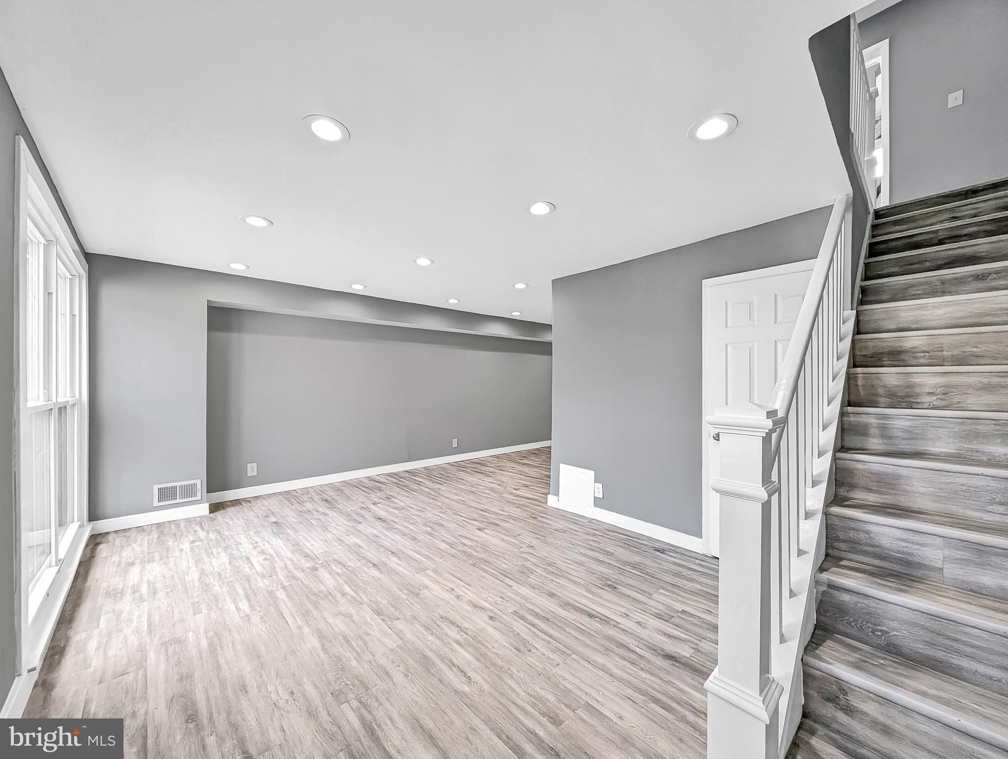 2240 15th Street Northeast Washington, DC 20018 - Photo 3 of 22 a view of an empty room with wooden floor and stairs