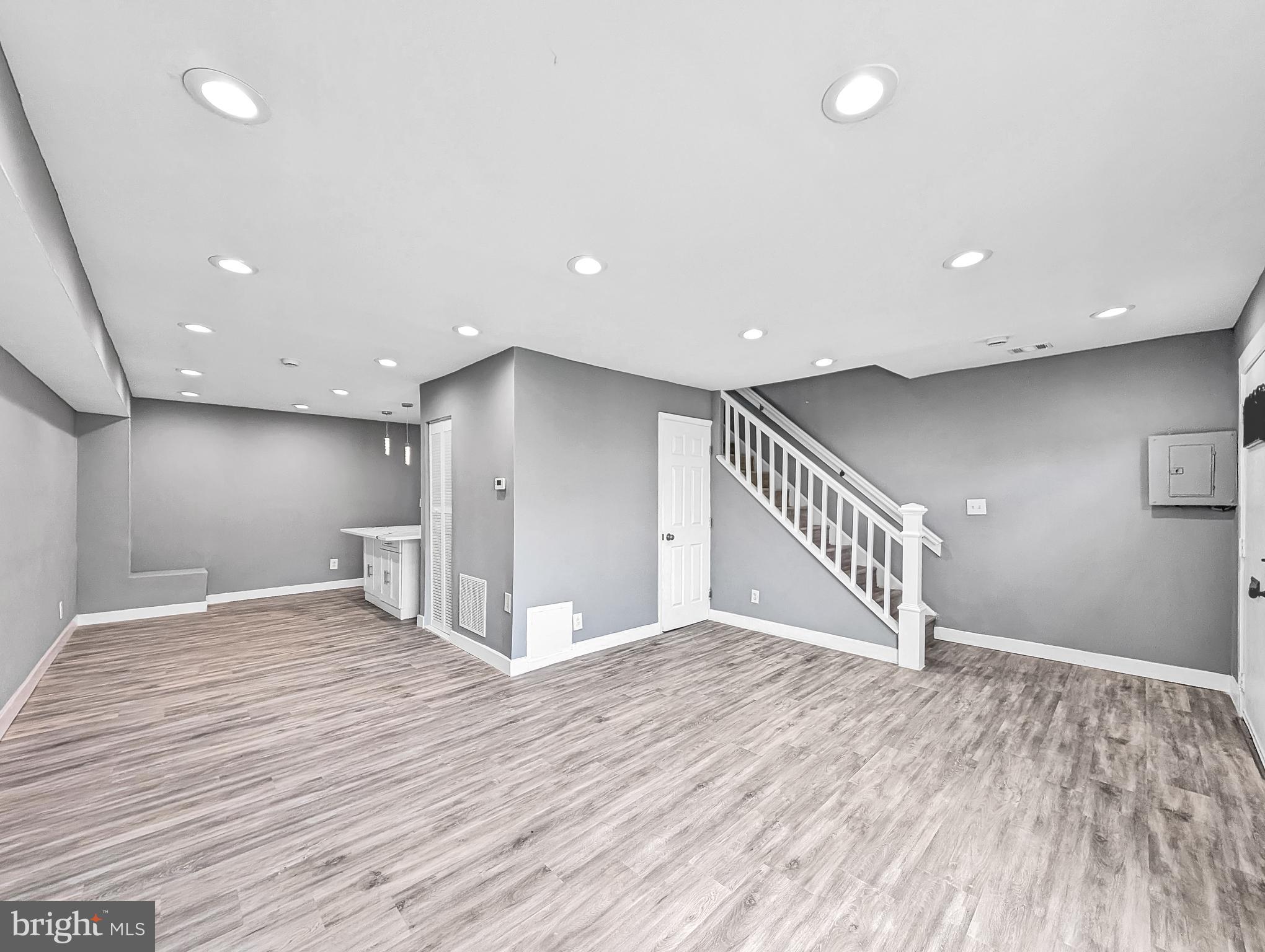 2240 15th Street Northeast Washington, DC 20018 - Photo 4 of 22 a view of an empty room with wooden floor and stairs
