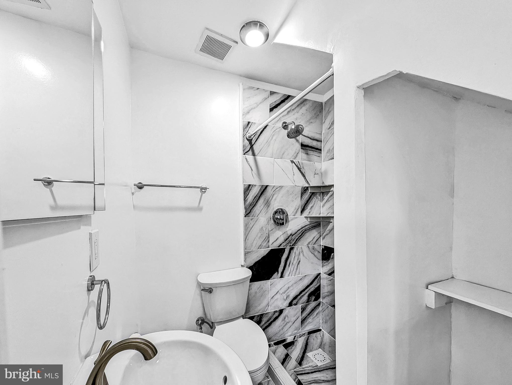 2240 15th Street Northeast Washington, DC 20018 - Photo 7 of 22 a bathroom with a toilet and a shower
