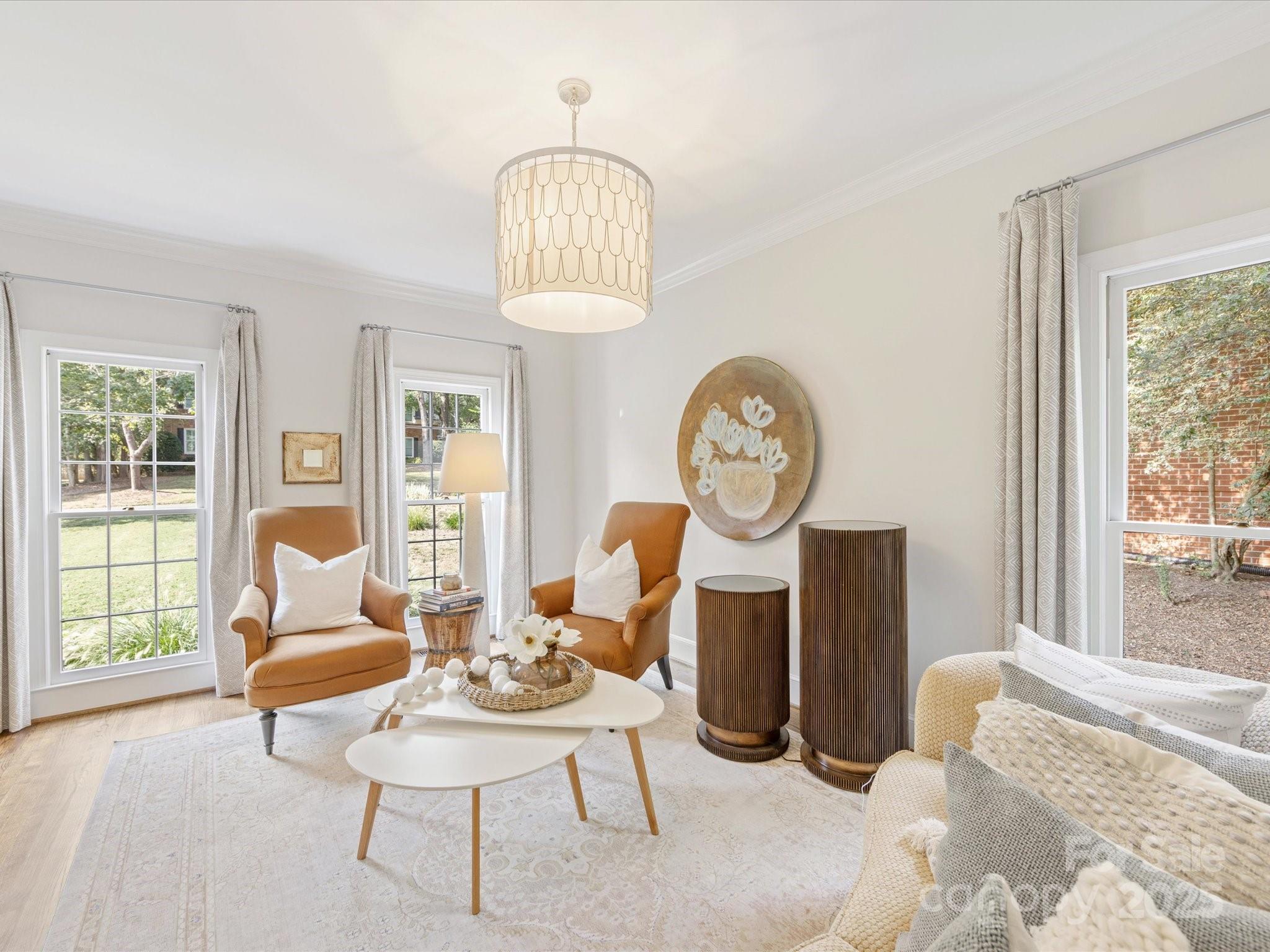 3137 Broadfield Road Charlotte, NC 28226 - Photo 13 of 42 a living room with furniture a window and a chandelier