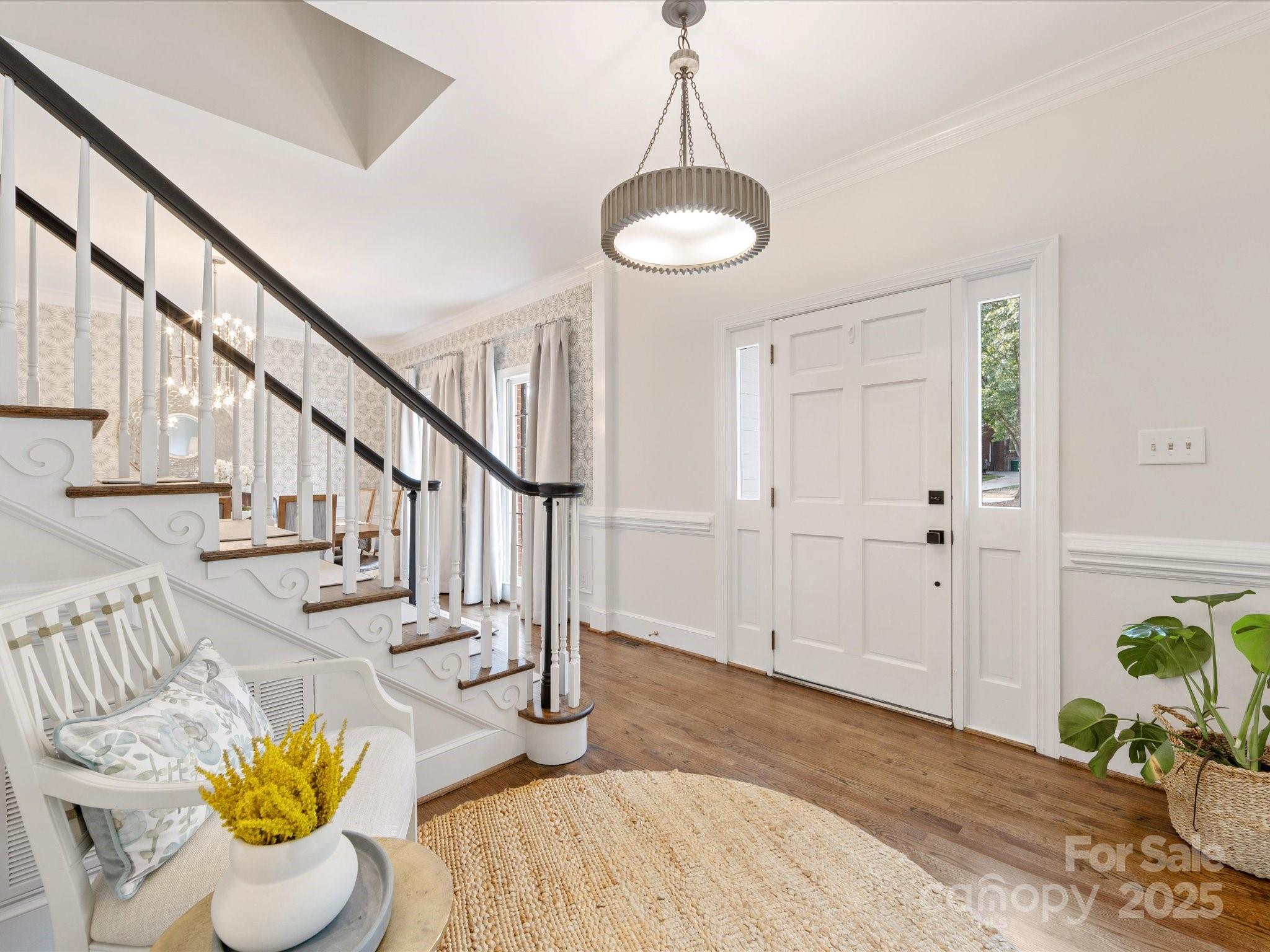 3137 Broadfield Road Charlotte, NC 28226 - Photo 16 of 42 a view of entryway dining room and hall with wooden floor
