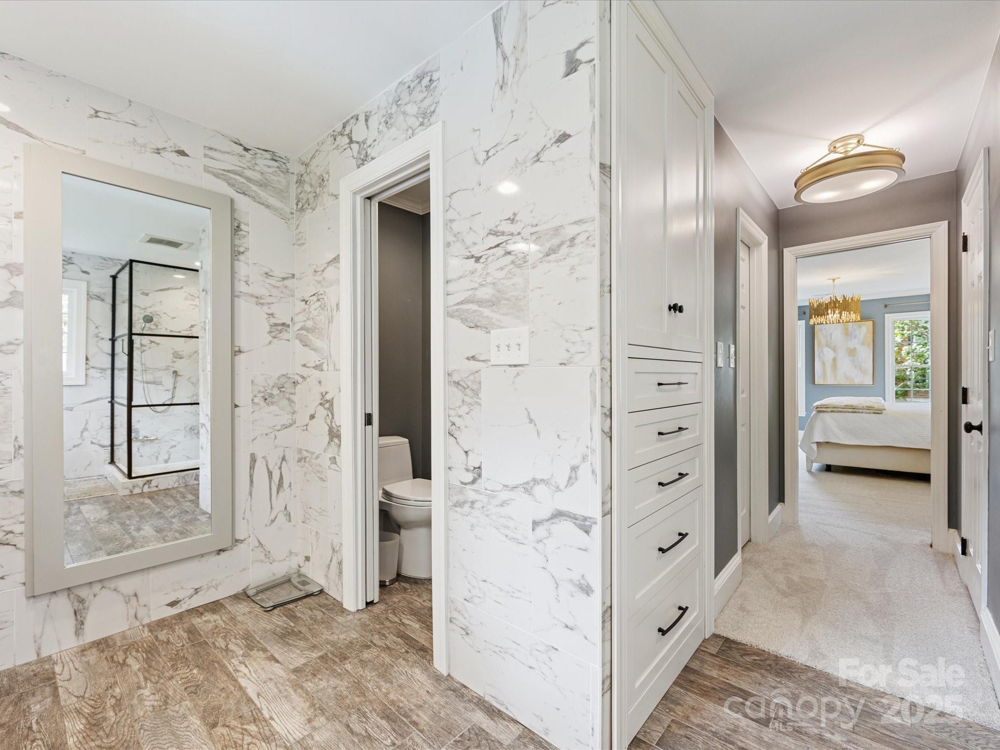 3137 Broadfield Road Charlotte, NC 28226 - Photo 23 of 42 hallway view with wooden floor and mirror