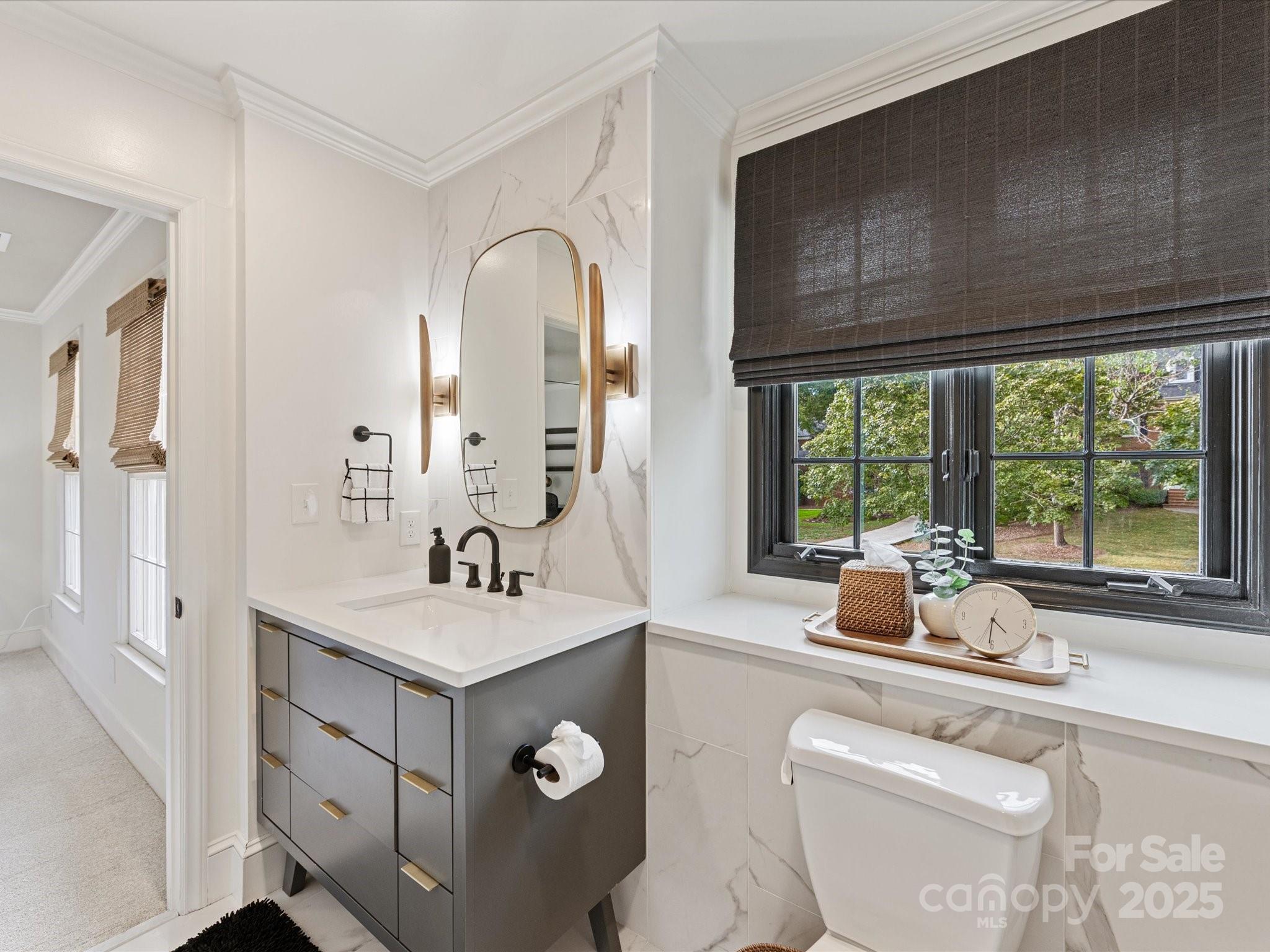 3137 Broadfield Road Charlotte, NC 28226 - Photo 27 of 42 a bathroom with a sink and a large mirror