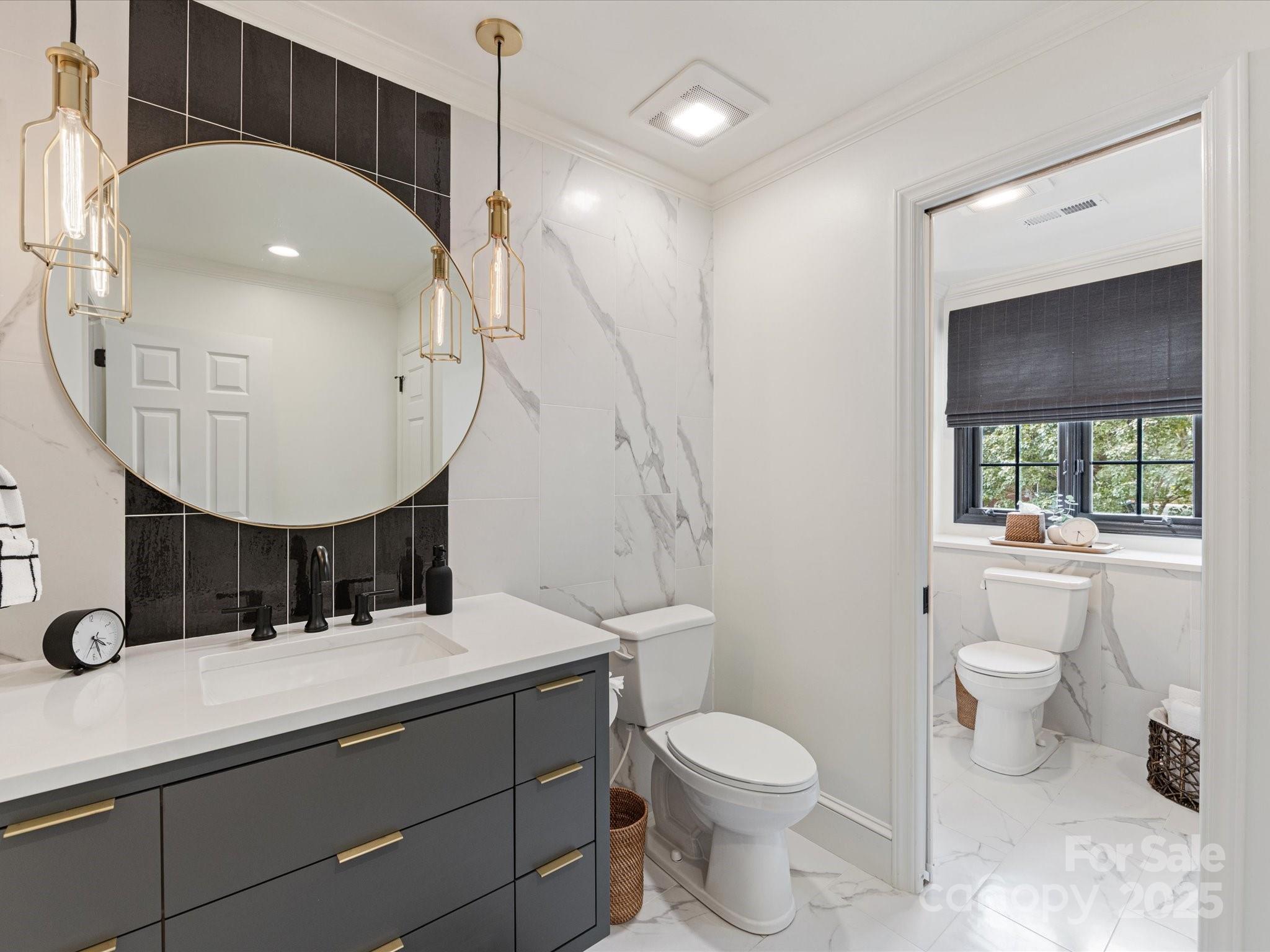 3137 Broadfield Road Charlotte, NC 28226 - Photo 28 of 42 a bathroom with a double vanity sink toilet and mirror