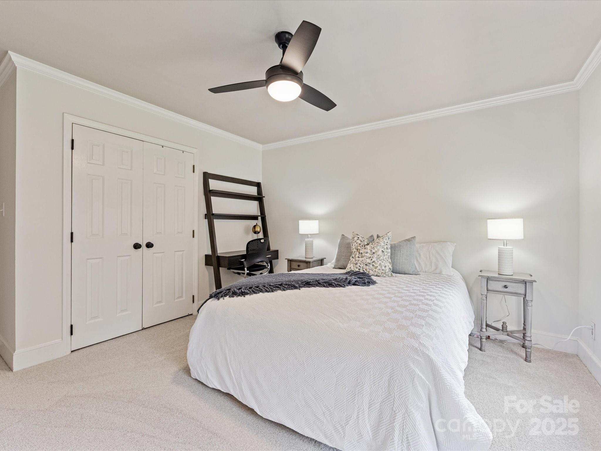 3137 Broadfield Road Charlotte, NC 28226 - Photo 29 of 42 a bedroom with a bed and a chandelier