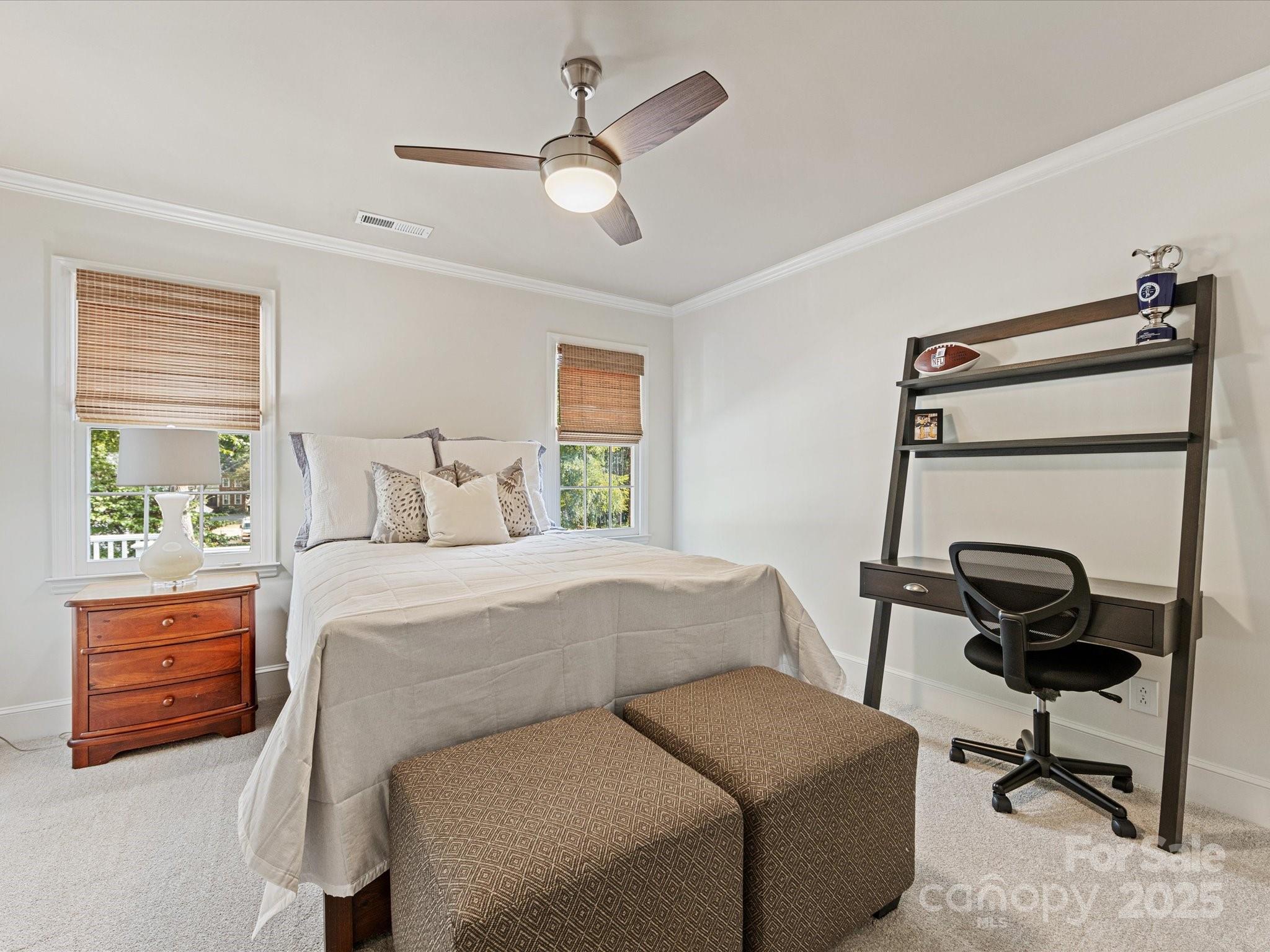 3137 Broadfield Road Charlotte, NC 28226 - Photo 30 of 42 a bedroom with a bed and a chandelier