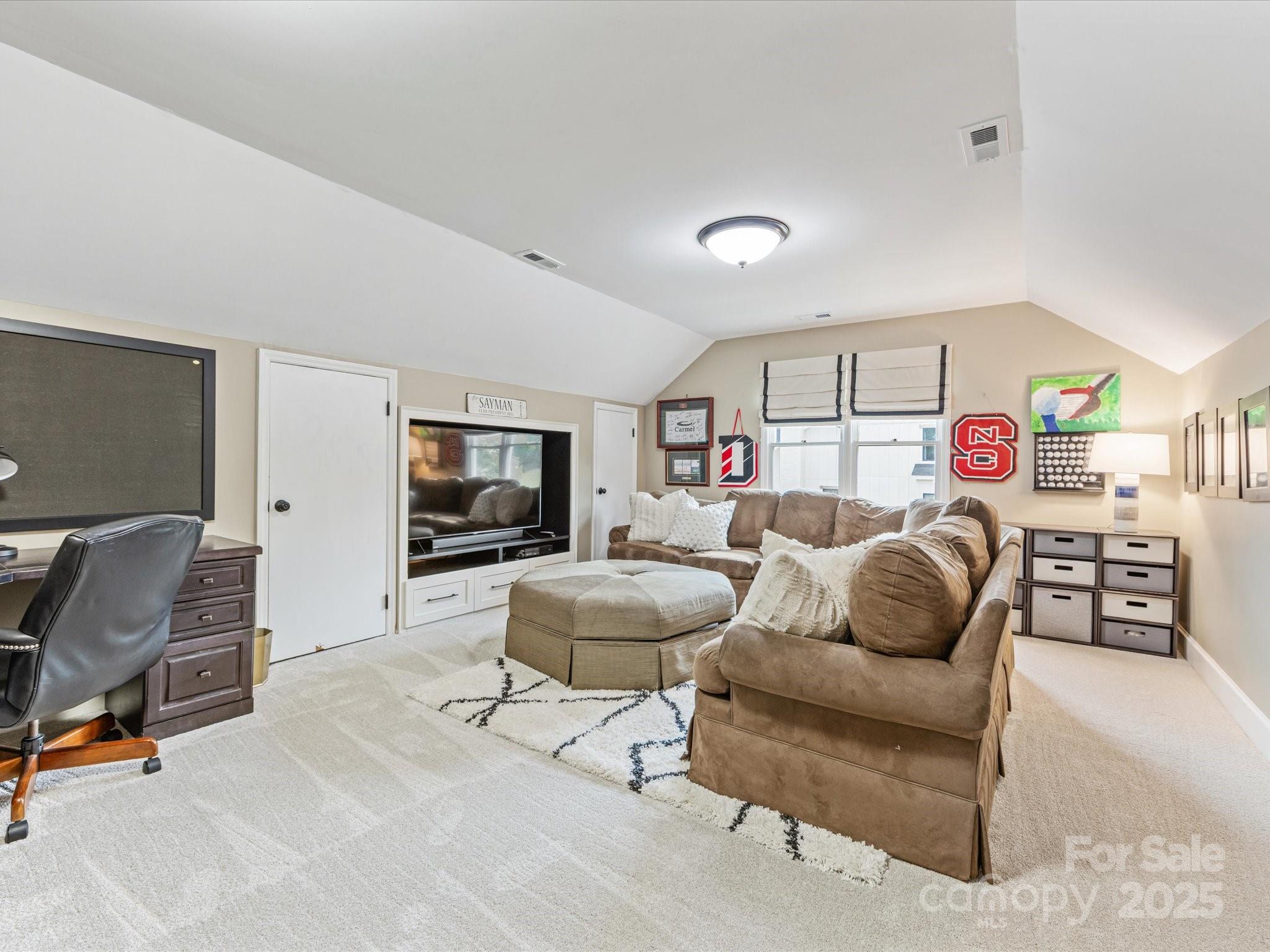 3137 Broadfield Road Charlotte, NC 28226 - Photo 32 of 42 a living room with furniture and a flat screen tv