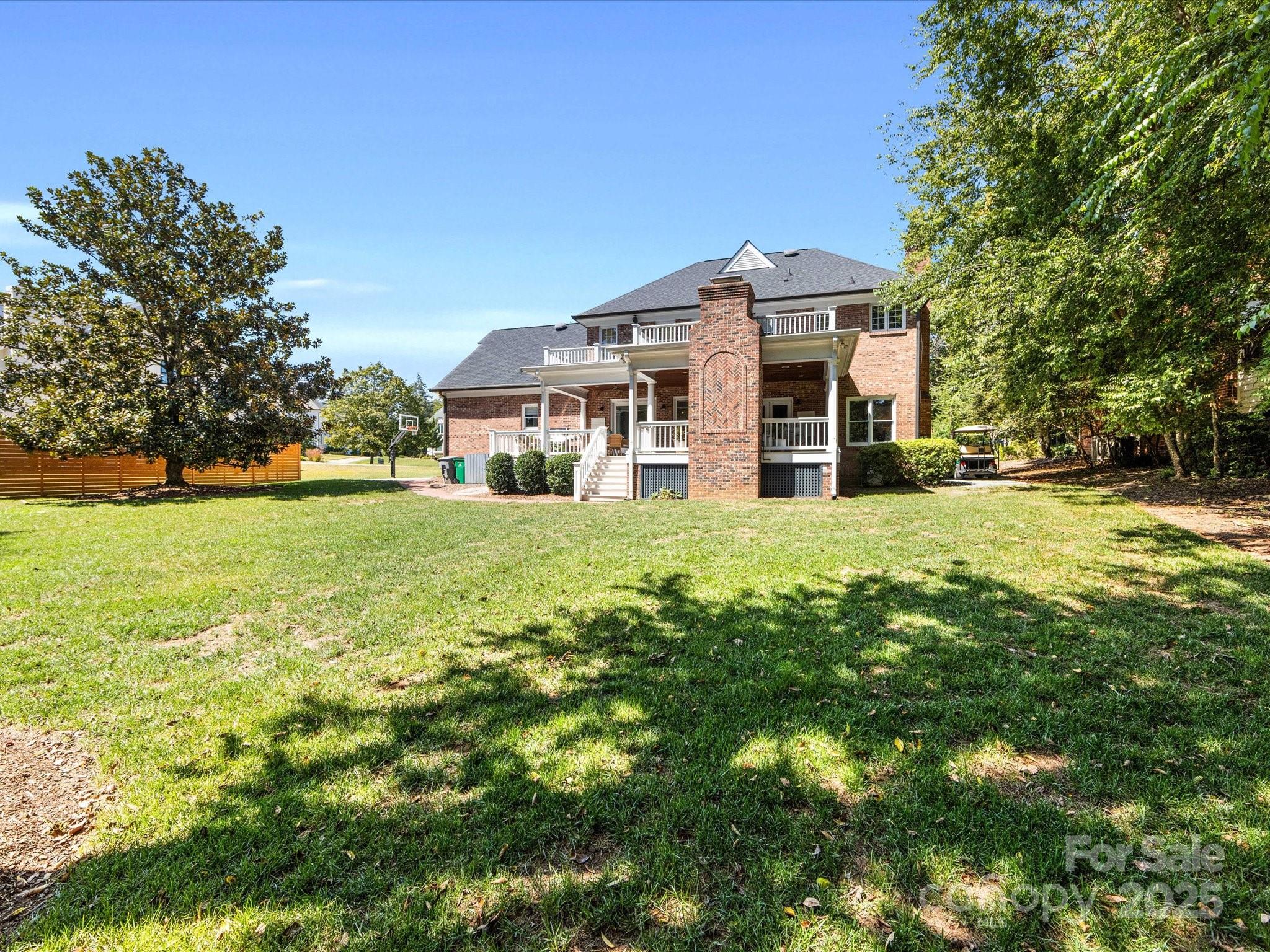 3137 Broadfield Road Charlotte, NC 28226 - Photo 41 of 42 a view of a house with a big yard and large trees
