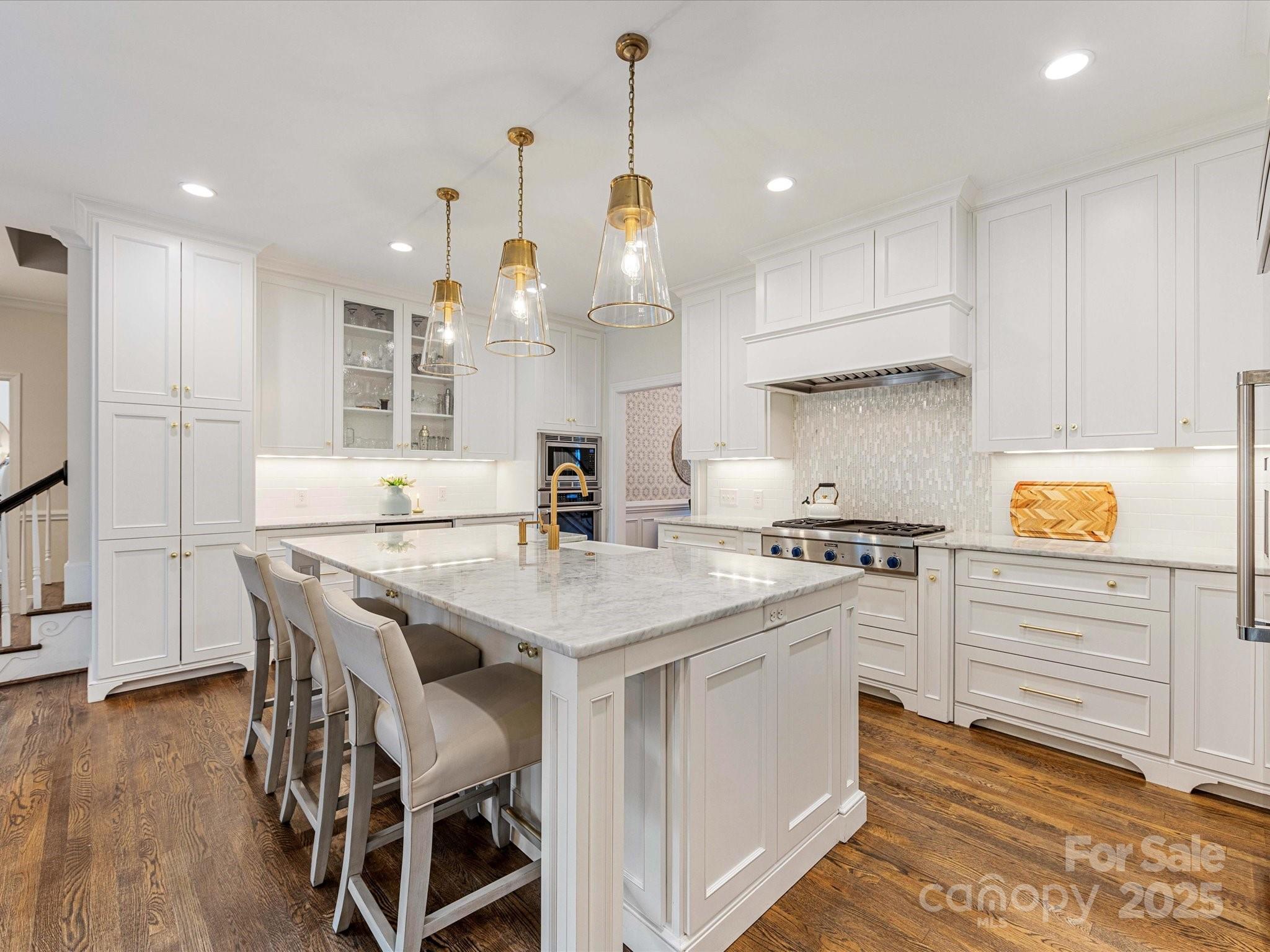 3137 Broadfield Road Charlotte, NC 28226 - Photo 5 of 42 a kitchen with a table chairs stove and cabinets