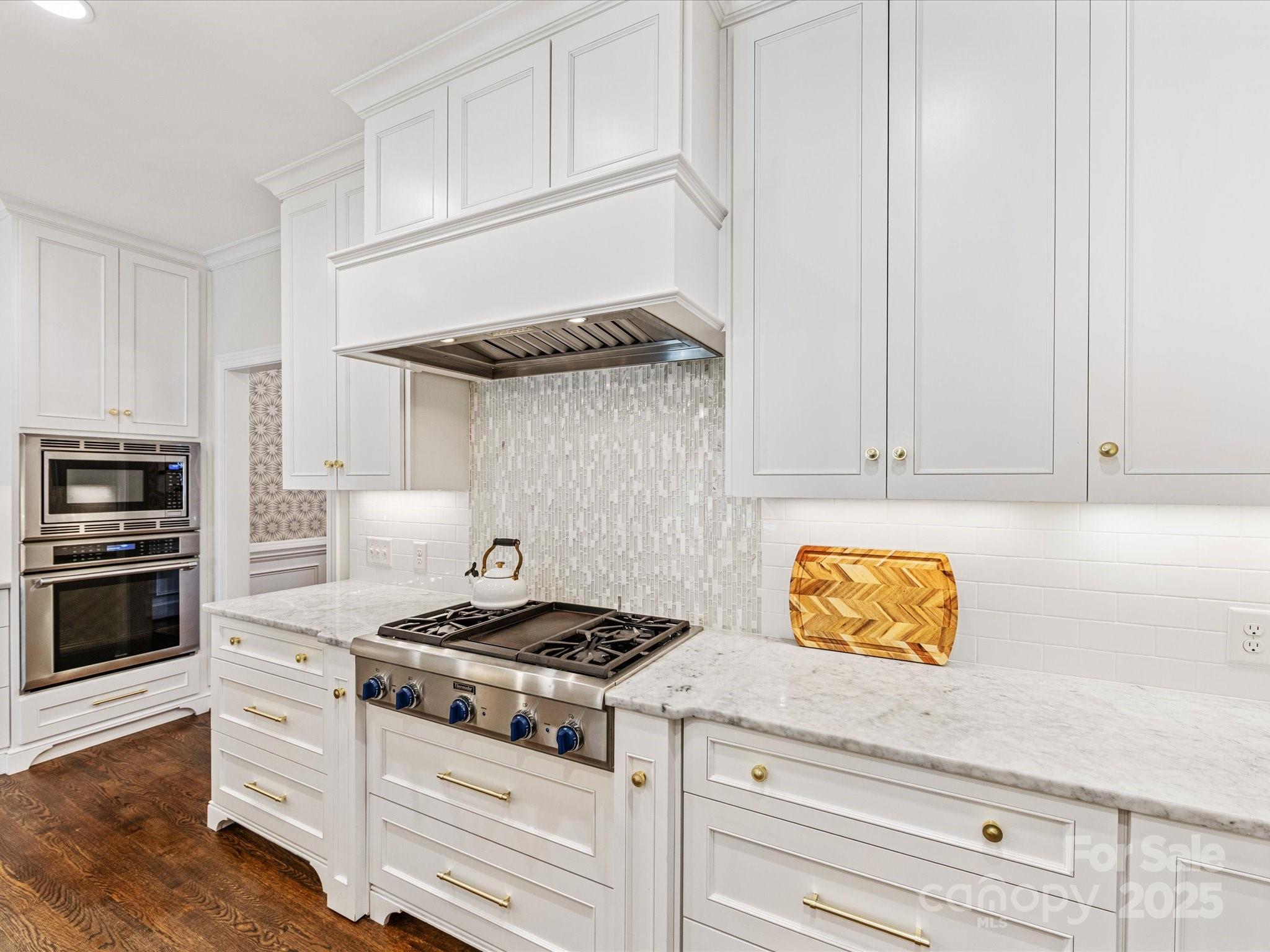 3137 Broadfield Road Charlotte, NC 28226 - Photo 8 of 42 a kitchen with stainless steel appliances granite countertop a stove a sink and a white cabinets