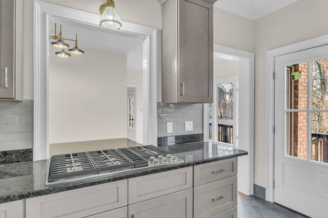 a kitchen with granite countertop white cabinets and a granite counter tops
