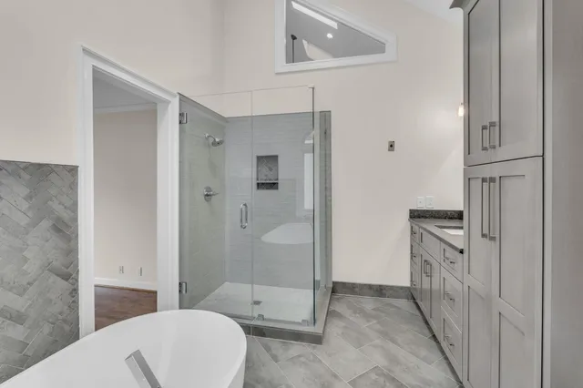 a bathroom with a granite countertop sink a toilet and shower
