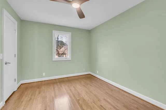 an empty room with wooden floor