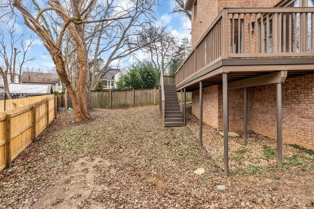 a view of a house with wooden fence