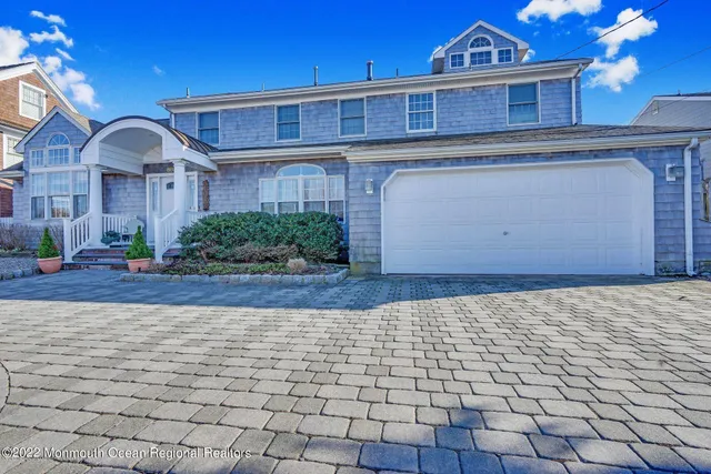 a view of a brick house with potted plants