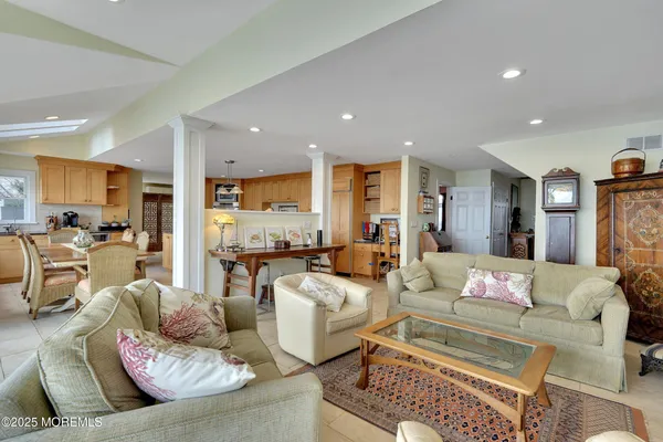 a kitchen with stainless steel appliances granite countertop a stove a sink and white cabinets