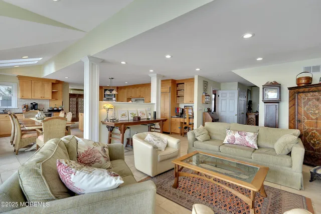 a kitchen with stainless steel appliances granite countertop a stove a sink and white cabinets
