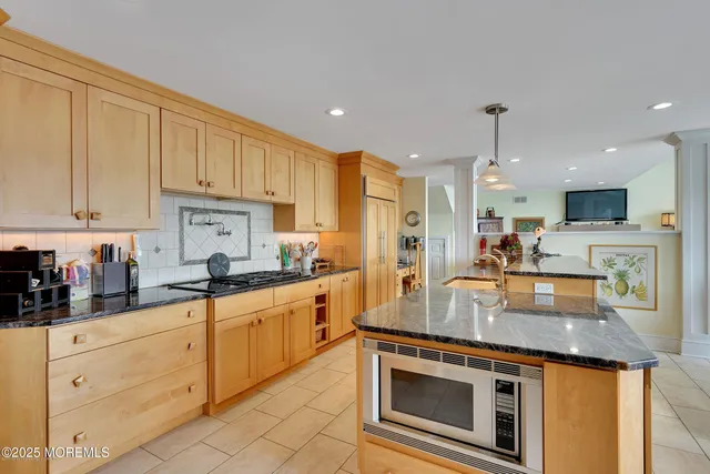 a large kitchen with kitchen island granite countertop a large center island attached withe living room