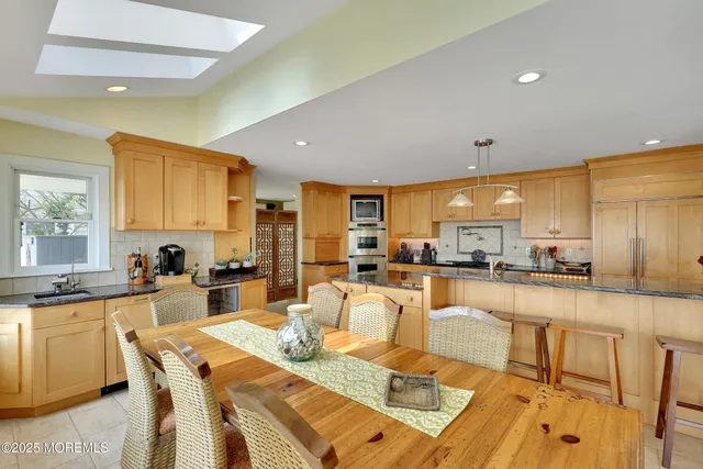 a view of a livingroom with furniture and large windows