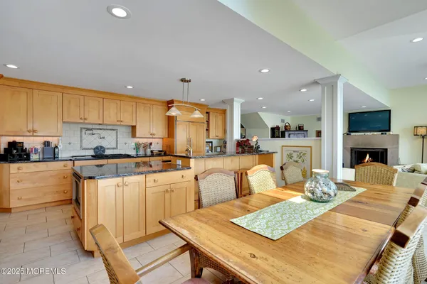 a large kitchen with a table and chairs