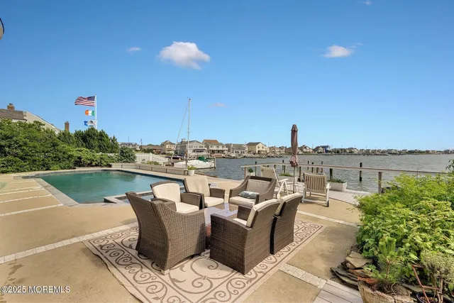 a view of a swimming pool and an outdoor seating