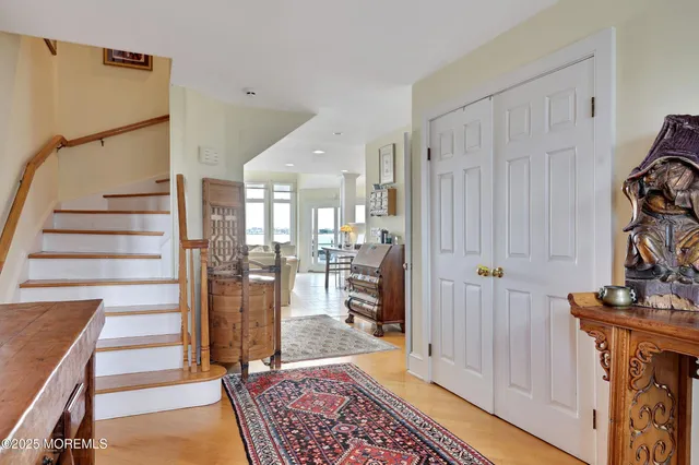 a view of a hallway with windows and cabinet