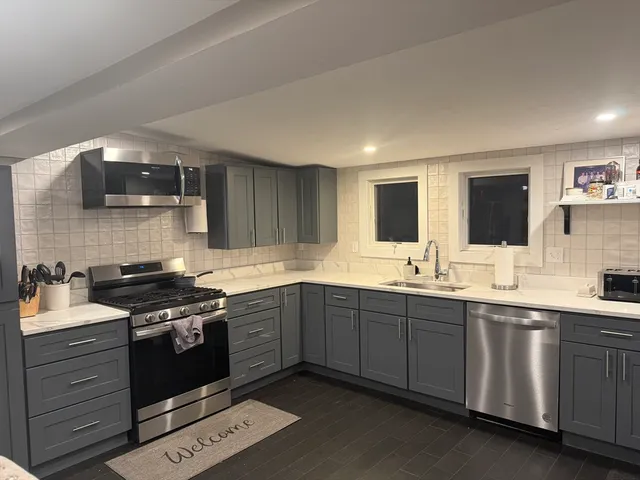 a kitchen with a sink and a stove top oven