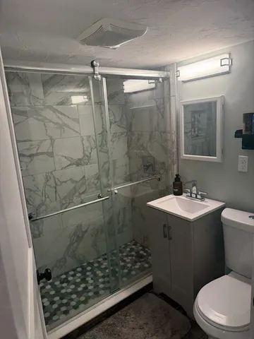 a bathroom with a sink toilet and shower