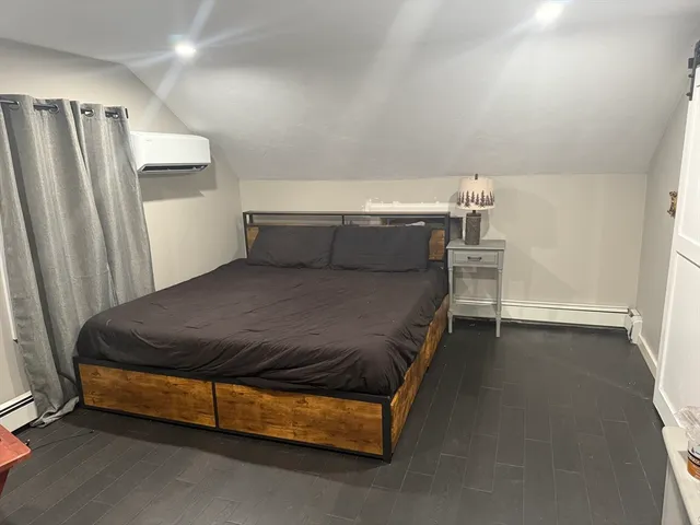 a bed sitting in a room next to a window