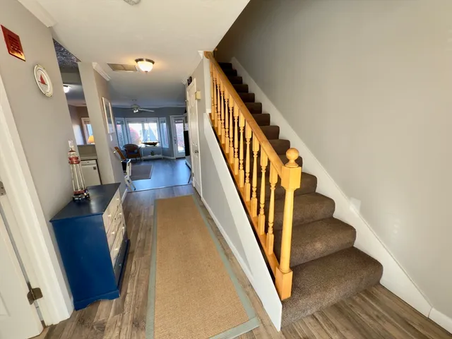 a view of entryway and hall with wooden floor