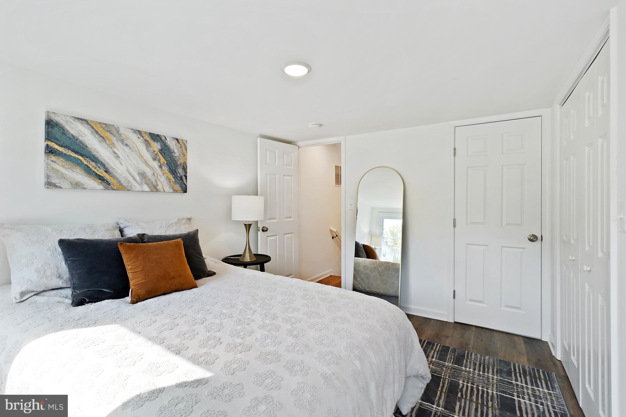3731 Falls Road Baltimore, MD 21211 - Photo 23 of 30 a bedroom with a bed and a painting on the wall