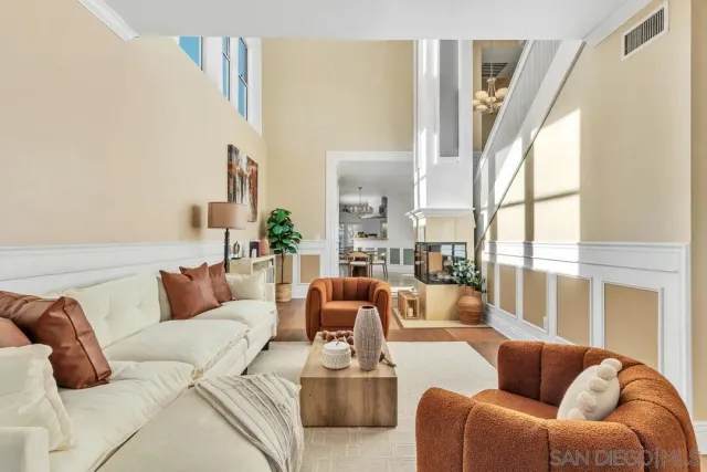 a living room with furniture a couch and a window