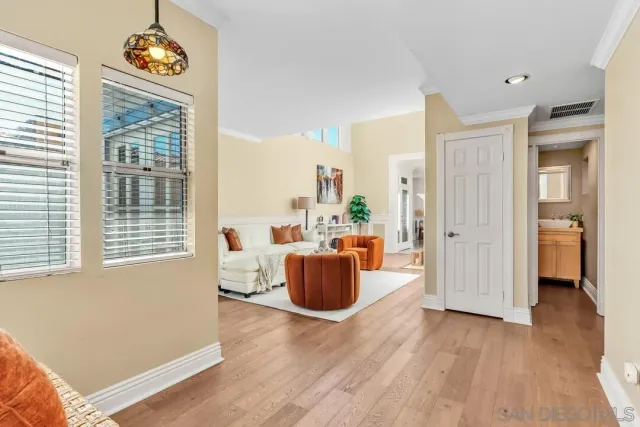 a view of a dining room with furniture wooden floor and a chandelier