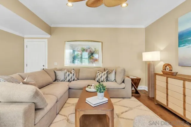 a view of a dining room with furniture and a potted plant