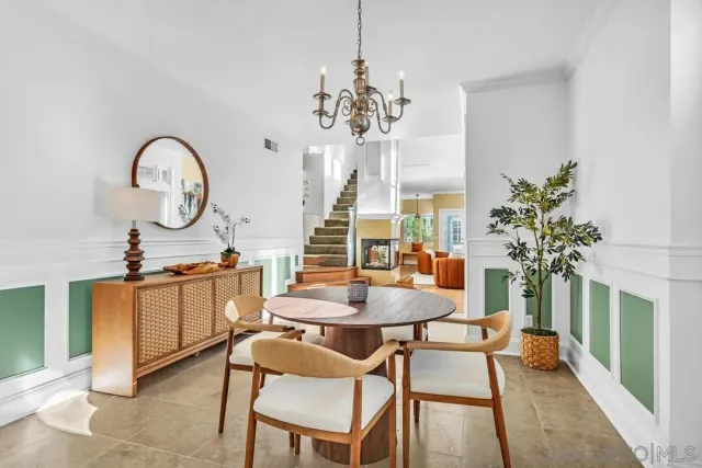 a bathroom with a tub a sink and a large mirror
