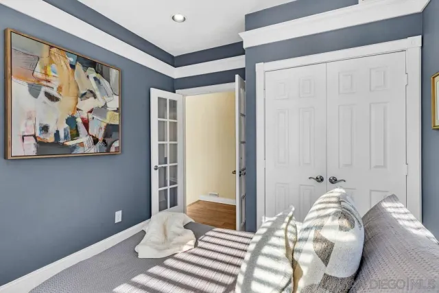 an aerial view of a city with lots of residential buildings and ocean view