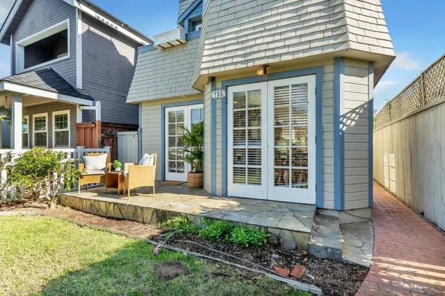 a living room with furniture and large windows