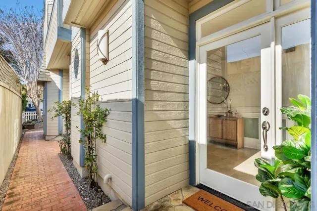 a living room with furniture a lamp and a large window